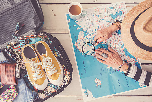 AdobeStock_212269064.jpeg travel, vacation, map, holiday, tourist, tourism, plan, planning, point, hand, pointing, showing, people, woman, preparation, summer, baggage, luggage, package, above, bag, journey, pack, passport, tour, concept, voyage, trip, indoors, top view, ready, stuff, suitcase, camera, organize, search, research, open, clothes, outfit, person, coffee, magnifying glass
